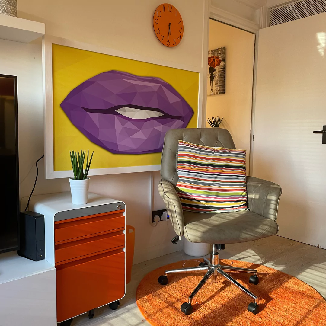 DropTop desk closed, displaying colourful artwork in a home office space.