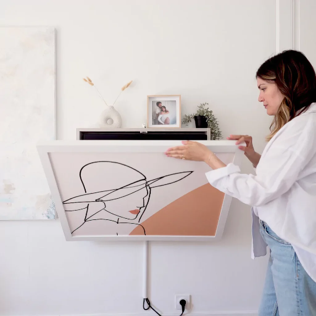 Person opening a fold-out DropTop desk mounted on a wall in a home setting.