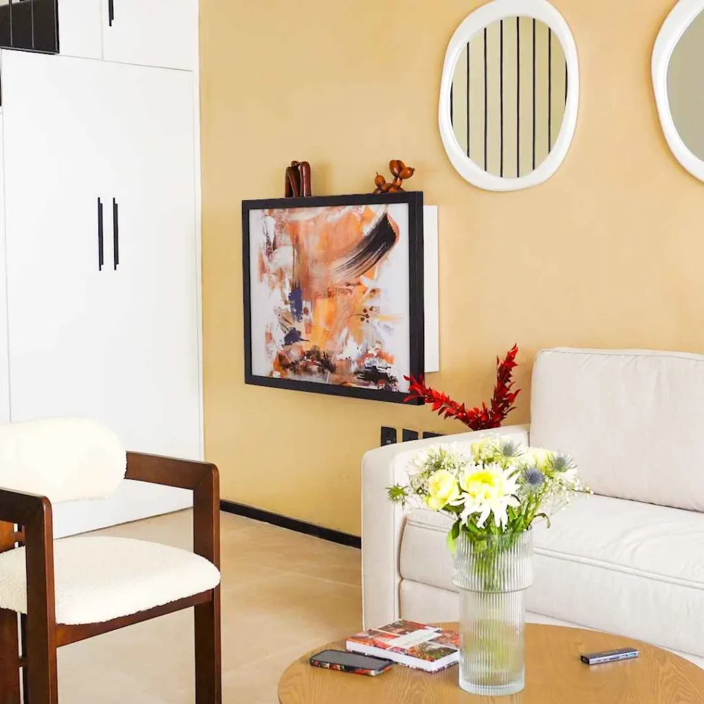 Hidden fold down desk disguised as abstract wall art in a modern living room