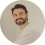 Profile photo of man with beard looking back with a friendly expression