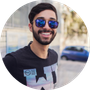 Portrait of a smiling man wearing sunglasses outdoors, used as a customer icon.