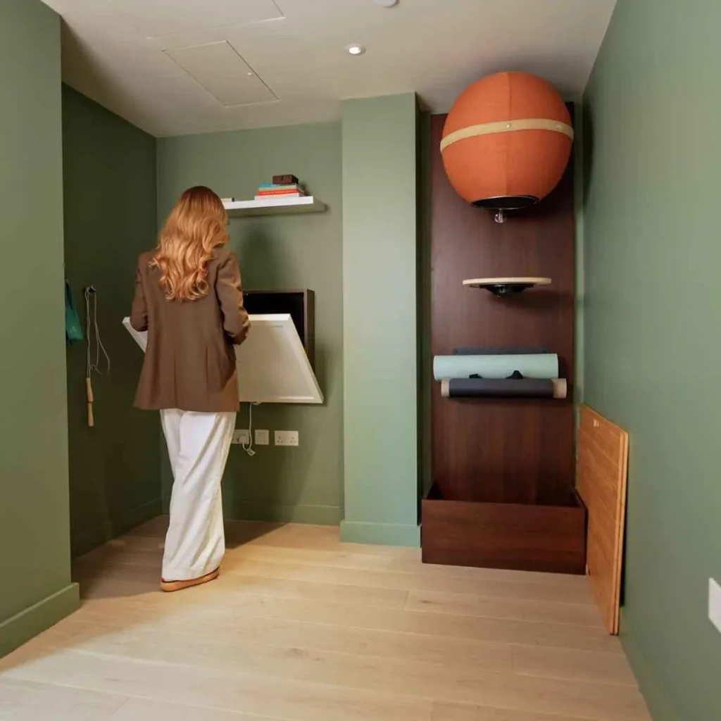 Person opening a DropTop desk with a whiteboard front panel.