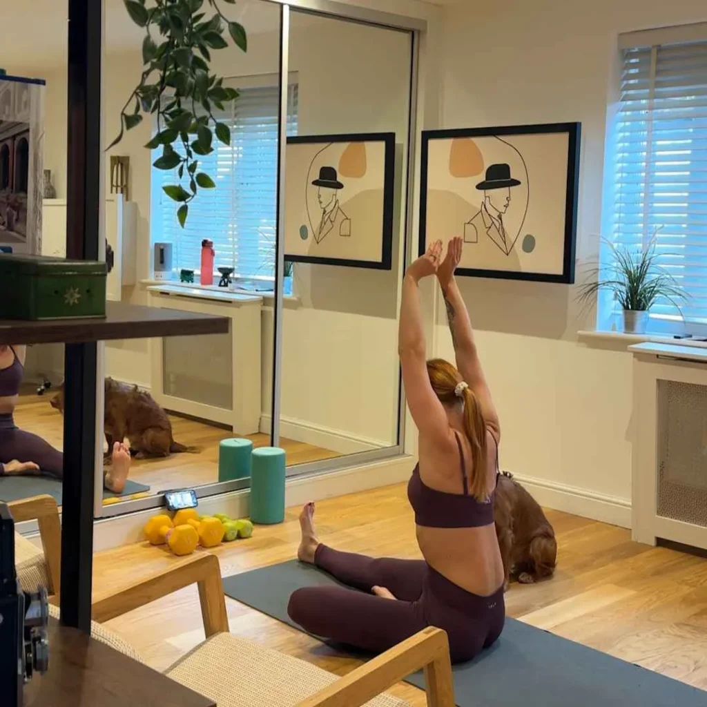 Person stretching in a home space with the DropTop desk closed.