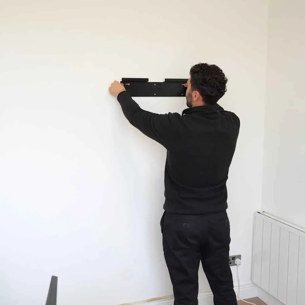 Installing a wall plate for a hidden desk in a home office setup
