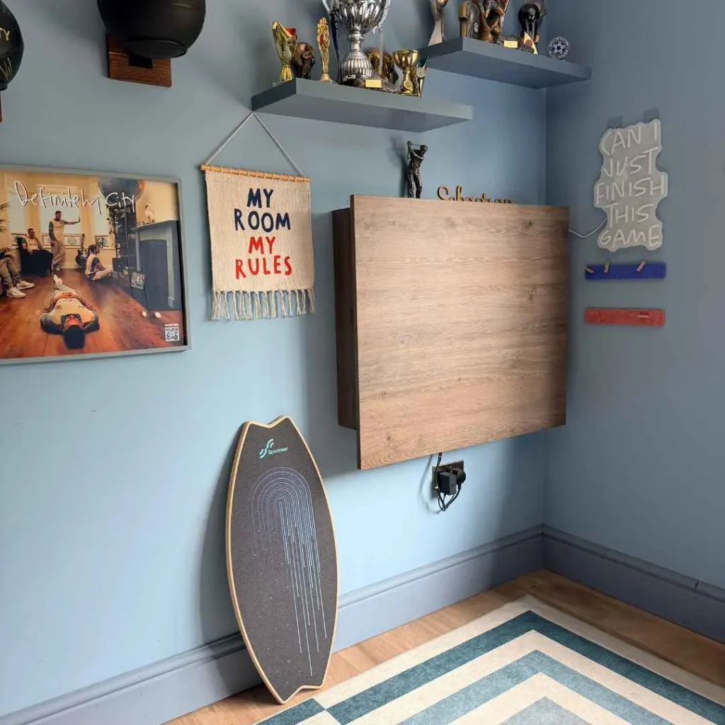 Compact wall mounted desk closed in a modern kids bedroom setup