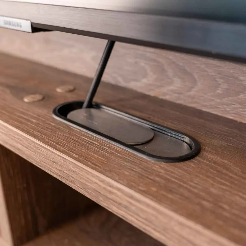Desk cable channel with sliding lid guiding monitor cables neatly through the surface