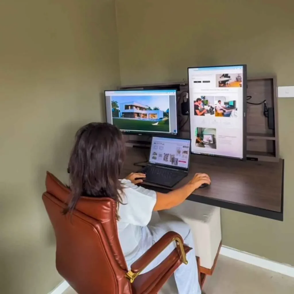 Remote worker using a multi screen workstation with vertical monitor and space saving desk
