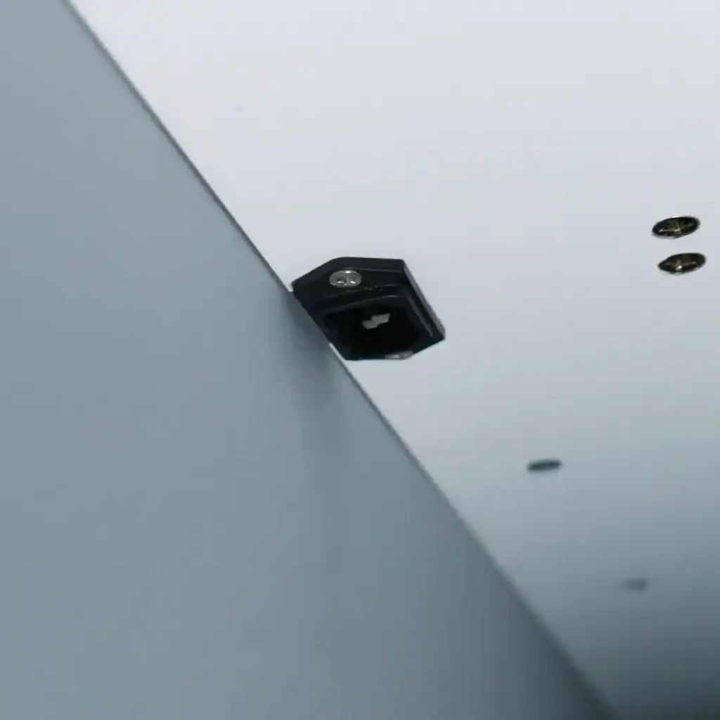 Close up of cable access slot for routing wires behind a wall mounted workstation