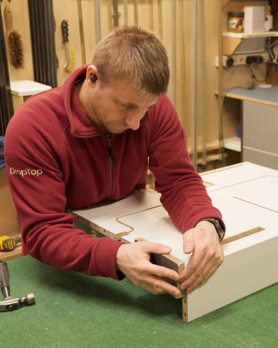 Craftsperson assembling a DropTop desk in the workshop.