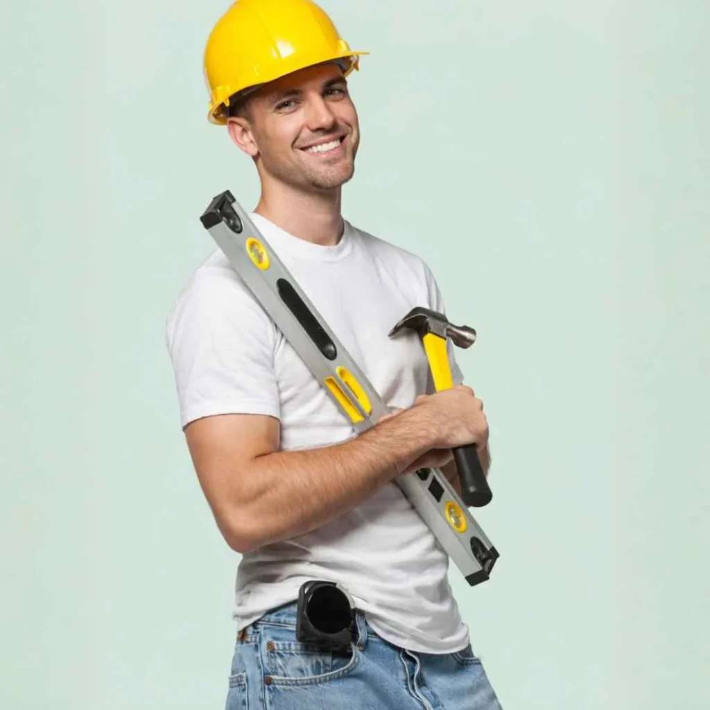 Installer holding tools, preparing to mount a DropTop desk.