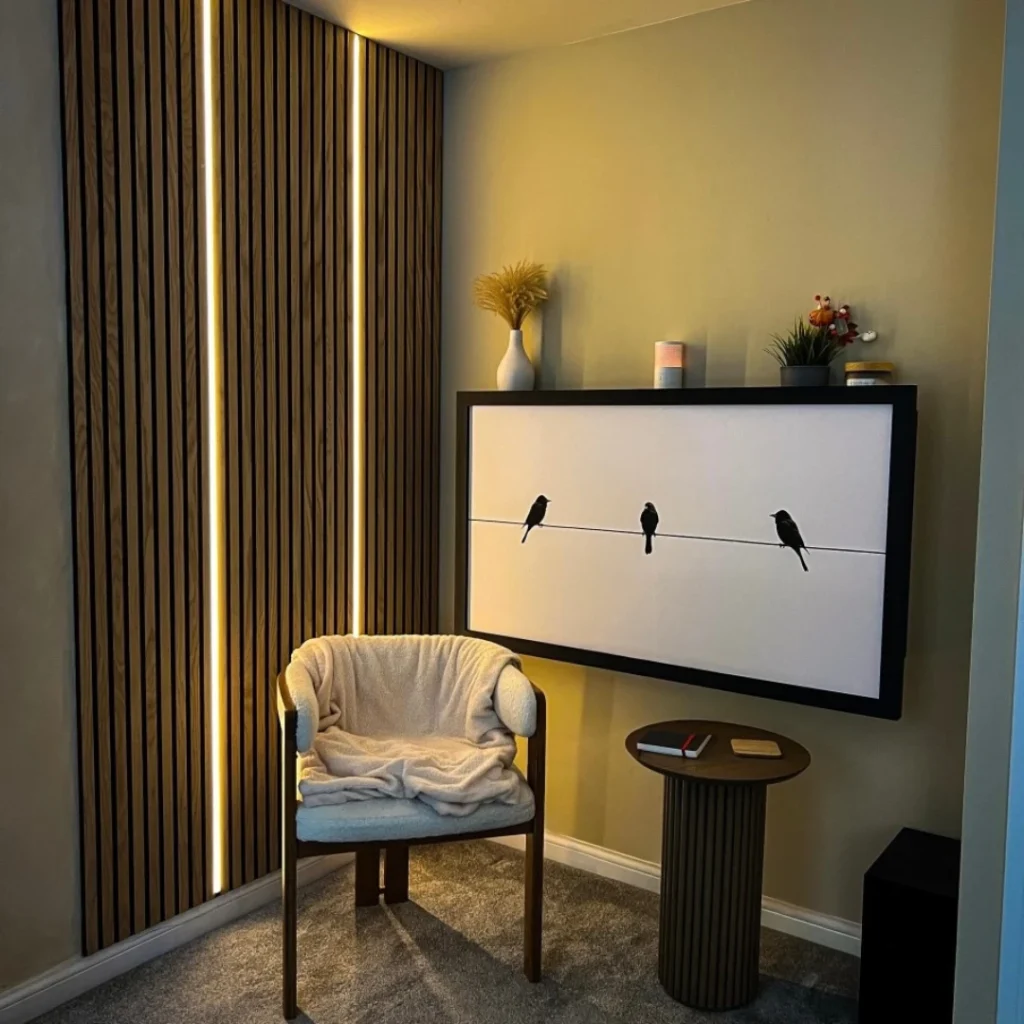 Minimalist wall mounted fold down desk styled as framed artwork in a cozy modern interior with soft lighting
