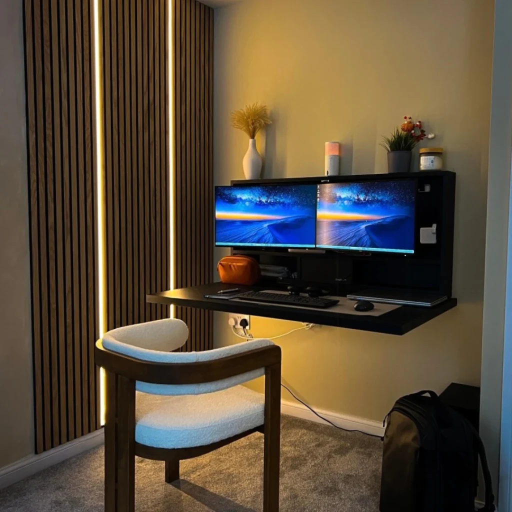 Modern wall mounted desk setup with dual monitors, ambient lighting and space saving home office