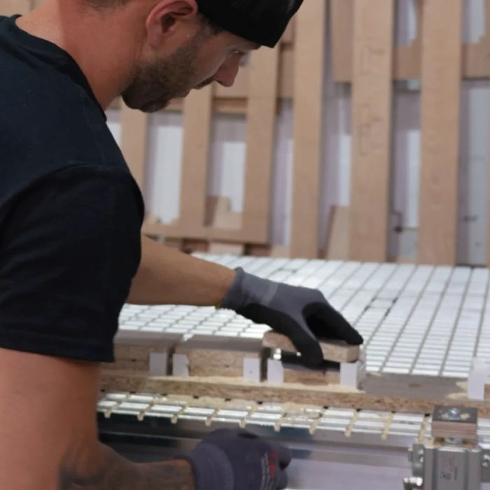 Wall-Mounted Folding Desks for Home Offices DropTop wall mounted desk panel being precision cut in workshop for folding hideaway desk design.