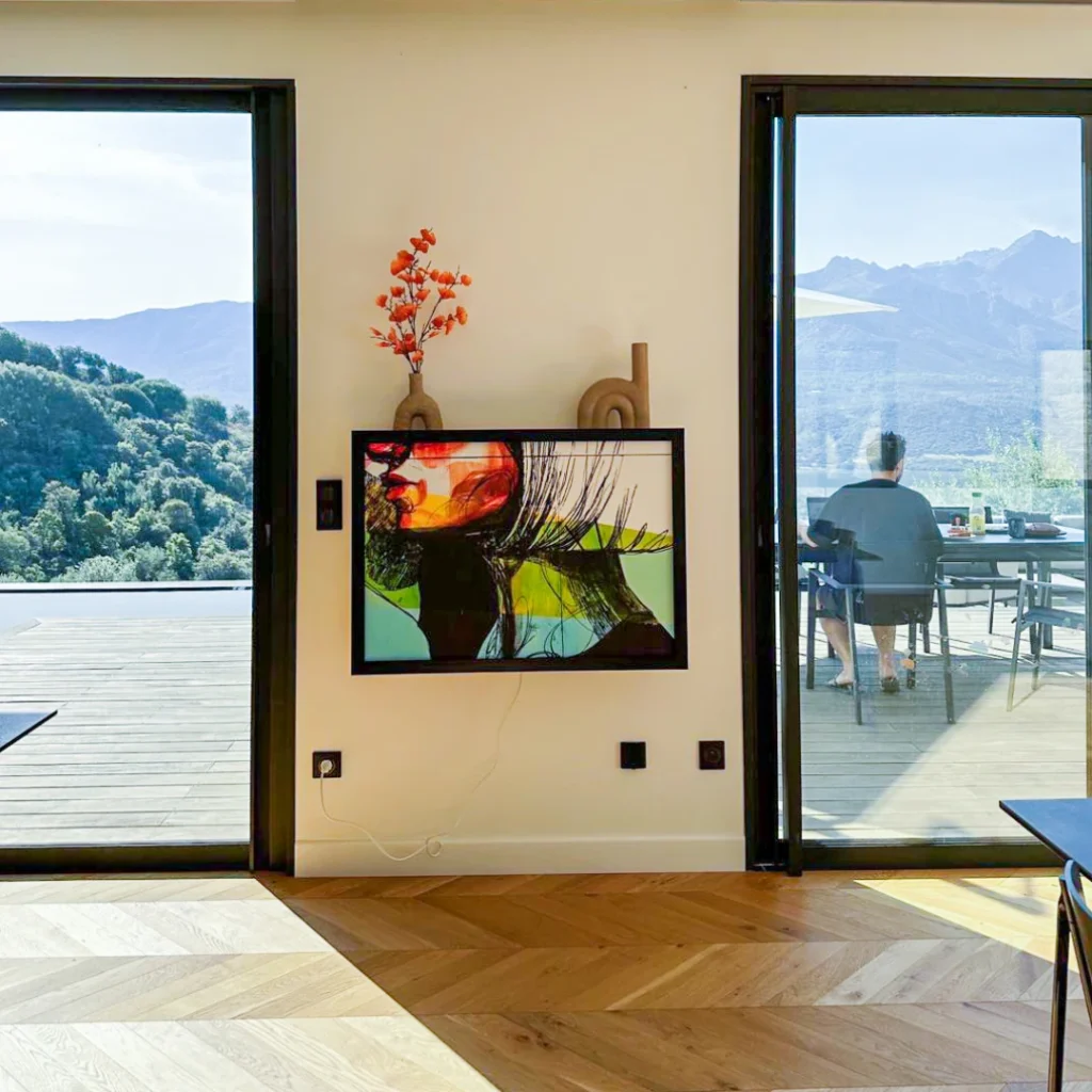 Hidden wall mounted desk disguised as artwork in modern interior with floor to ceiling windows